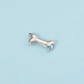 Detailed view of silver bone pendant with blue crystal on a light blue background - Steel Color March