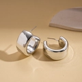 Detailed close-up of chunky silver C-shape metal hoop earrings on a stone display - Silver C-Shape (Steel Pin)