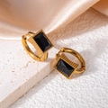 Detail of vintage gold star earrings featuring emerald-cut black zircon on stone base - Square Zircon / Black