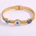 Detail of gold evil eye bangle with enamel charms and feathered texture surface - Three Eyes Open Bangle