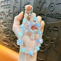 Luminous balloon dog beaded phone strap with iridescent blue and purple charms - Blue