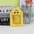 Detail of yellow plush photocard holder with cartoon embroidery and a blue striped bow - Yellow Chick