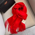 Vibrant red 100% Australian wool scarf featuring elegant tassels and a white care label - Red
