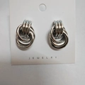 Three-circle intertwined silver stud earrings with a polished finish on a jewelry card - 15x24 Silver Style