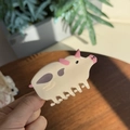 Close-up of animal cow hair claw clip made of acetate fiber with a strong grip - Pig