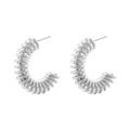Macro detail of silver-colored C-shaped spiral hoop earrings with a metallic coiled design - C-Shape Spring Style (VE1033) / White Gold