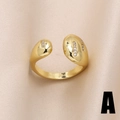 Bague ouverte dorée élégante ornée de zircons brillants sur un fond de satin raffiné - Style A-Zircone Goutte d'eau
