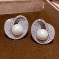 Detailed close-up of a silver earring featuring a twisted ring with pavé zircons and a pearl - 31# Silver Zirconia Round Pearl Studs