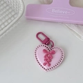 Close-up of pink Y2K heart keychain with bow tie detail and pink lobster clasp - Light Pink Heart