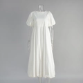 Detailed view of white cotton dress featuring puffy sleeves and high waist pleated design - S / White