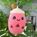 Detail of pink milk tea plush keychain with embroidered watermelon face on plant branch - 11cm / Melon Red