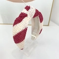 Detail of red and white striped straw woven headband featuring a knot and textured fabric - Wine Red & Beige Wide Stripe