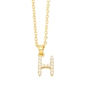 Macro detail of golden H-shaped pendant necklace featuring inlaid small white pearls - Gold Letter H