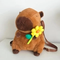 Brown Capybara plush backpack with a yellow sunflower decoration and adjustable straps - Holding Yellow Flower (Webbing Strap)