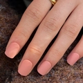 Short square matte press on nails in soft dusty rose pink shown on hand with gold ring - Glue Type / Matte Nude Pink (JP3179)
