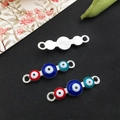 Detailed macro view of silver evil eye connectors in red and blue on a black background - Bright Silver - Three-Color Evil Eye Connector - 25x7mm