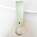 Detail view of light green leather keychain strap with premium gold metal ring - Light Green