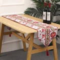 Detailed view of knitted Christmas table runner with festive reindeer patterns and tassels - Knit Reindeer