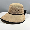 Women's foldable hollow straw sun hat in light brown with a black bow and wide brim - One Size / Khaki