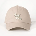 Detail shot of Good Vibes white embroidery and crown on beige cotton baseball cap - Adjustable / Light Khaki