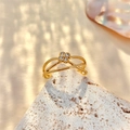 Macro detail of gold layered crossover ring featuring four zircons on a white mineral stone - Adjustable Open / Stainless Steel/Zirconia / Cross Hollow Flower / Gold