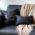 Detail of two black velvet pillows with gold Sweet Home text on a black leather sofa - 30*50cm / Black Home Sweet Home Gold Bronzing