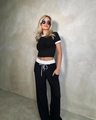 Detail of black crop top and drawstring wide leg pants with contrast white trim - S / Black