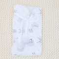 Detailed view of white faux fur wine bottle cover featuring silver snowflakes and pom-poms - Silver Snowflake
