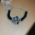 Detail of camellia flower bracelet with black beads and sparkling crystals inlay - Silver-tone Black Bracelet