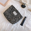 Detail of zebra pattern woven fabric bag with Time to Party label on cotton texture - Black