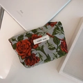 Detail shot of mini floral canvas pouch with red rose jacquard and zipper closure - Red Rose with Green Leaves