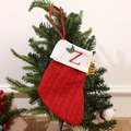 Red knit Christmas stocking with embroidered letter Z hanging on a festive tree - Letter Z