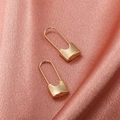Minimalist gold safety pin earrings on pink silk background with metallic finish - KC Gold Lock Earrings (wg-0622)