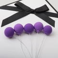 Five purple clay balloon cake toppers with flexible wires and black ribbon on white background - Single Piece / Purple Single Ball