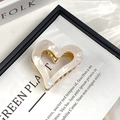 Detailed view of pearlescent white heart-shaped acetic acid hair claw with gold metal spring - Heart Mermaid White
