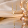 Elegant gold moon and star pendant necklace displayed on warm silk fabric background - Gold White Shell Star Moon