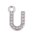 Detailed macro view of silver U-shaped pendant with sparkling clear rhinestones - Letter U