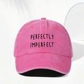 Macro shot of PERFECTLY IMPERFECT black embroidery on a pink washed cotton baseball cap - Rose Red