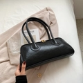 Elegant vintage black leather Boston bag with gold hardware on a minimalist suit - Black