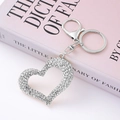 Close-up of heart-shaped keychain with sparkling rhinestones and lobster clasp - Silver Hollow Full Rhinestone Heart