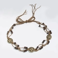 Detail of bohemian braided waist belt with wooden beads and floral bronze medallions - 3 Yellow Oval Beads