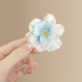 Blue and white gradient mesh flower hair clip featuring a detailed yellow stamen center - Blue Cherry Blossom