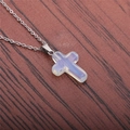 Macro shot of polished stainless steel chain with a translucent opalite cross pendant - Opalite Cross