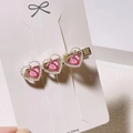 Gold hair clip with three pearl-edged pink peach hearts on a white display card - Pink Pearl Peach