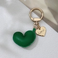 Green leather heart keychain with gold-tone hardware and engraved Love metal tag - Dark Green