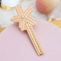 Detailed view of a gold hair clip with white pearls arranged in a star pattern - Style 06-Cross Pearl