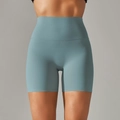 Front view of high waisted fitness shorts in light blue with tummy control seamless design - Mystery Green