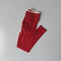 Detail of red seamless yoga pants with white high-waist ribbed waistband and peach contouring - Cherry Red