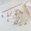 Macro view of floral quilted cotton drawstring pouch for camera and small accessories - Patchwork Berry