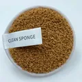 Macro shot of round fiber cleansing sponge with white silk tag and plush brown texture - Cloud Velvet Coffee
